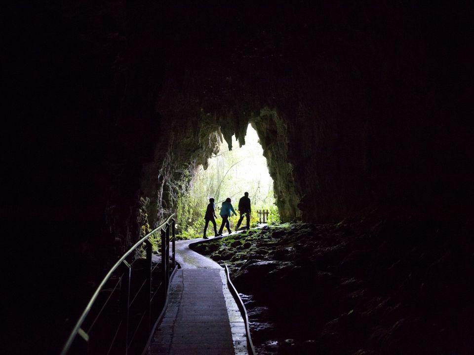 People Walking Inside Glowworm Cave